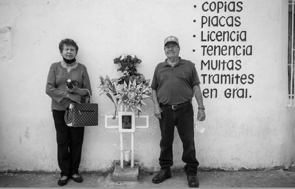 Photo of Dona Taide and Don Jose standing at the spot their grandson was killed by a Border Patrol agent.